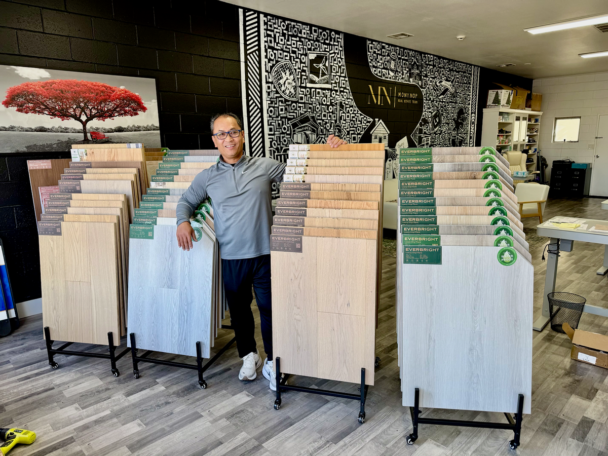 Mony Nop, founder of Floors by Mony, with flooring sample racks in the Livermore showroom